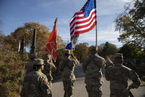 A formal procession marches to the grave of Grace Banker. Photo by John McCarten