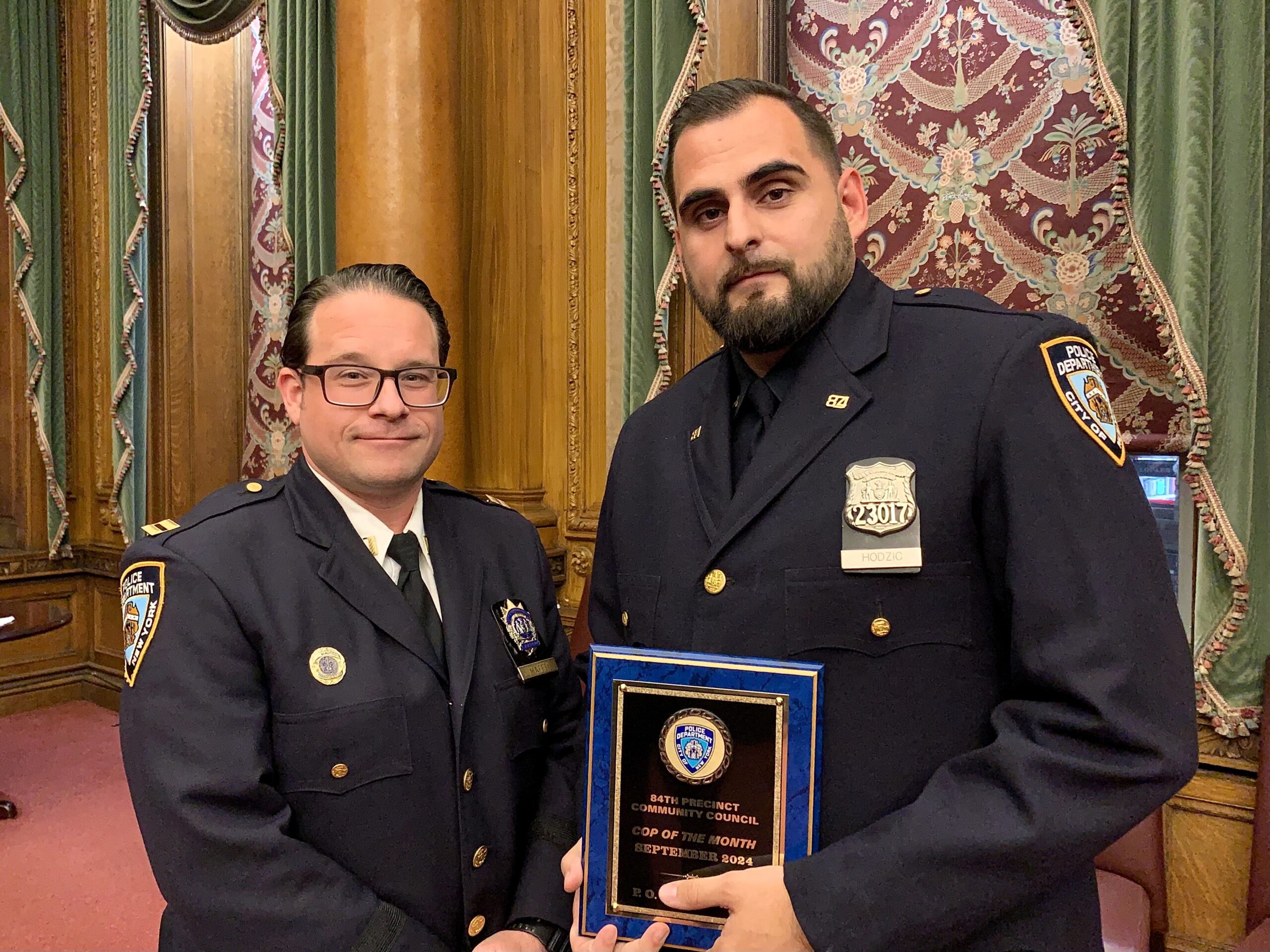 P.O. Vahid Hodzic, right, was honored as the 84th Precinct Community Council’s "Cop of the Month" for his take down in September of an armed suspect near courts and schools in Downtown Brooklyn. Presenting his award was the 84th Precinct’s Commanding Officer Capt. Thomas Maffei. Photo: Mary Frost, Brooklyn Eagle