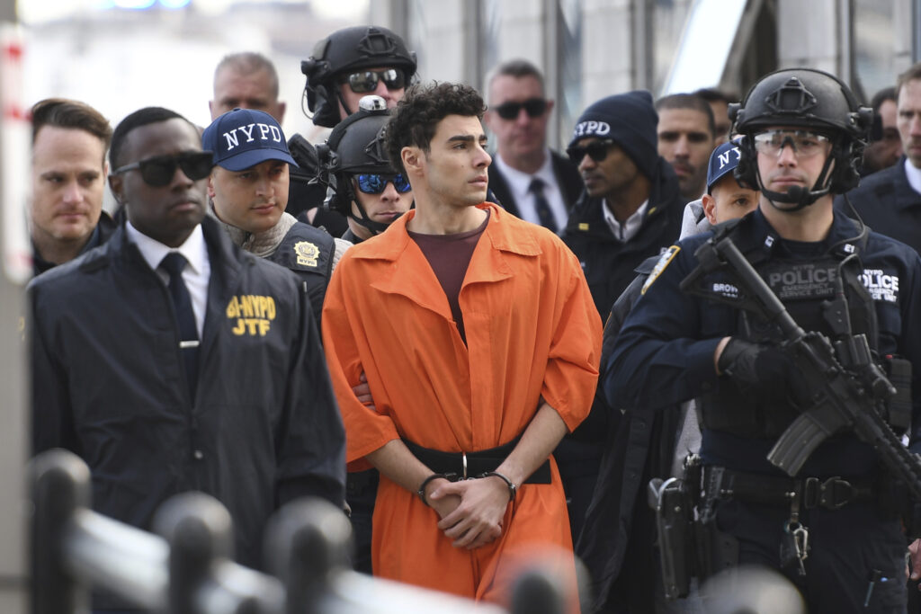 Luigi Mangione, a suspect in the fatal shooting of UnitedHealthcare CEO Brian Thompson, is escorted by police Thursday, Dec. 19, 2024, in New York. AP Photo/Pamela Smith