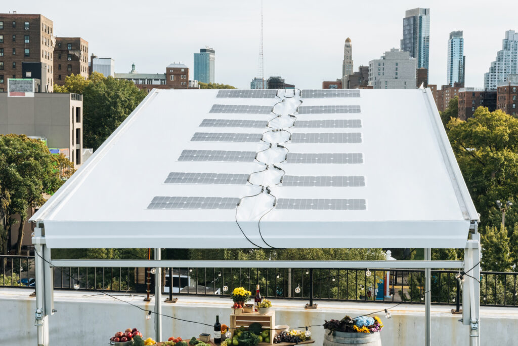 One of Pvilion's portable products, a lightweight solar canopy. It comes with discreet batteries and can power lighting and event gear and charge mobile devices silently and emission-free anywhere. It has removable sidewalls and was designed for outdoor dining, farmers markets, outdoor events, and anything else you can think of. Photo courtesy of Pvilion