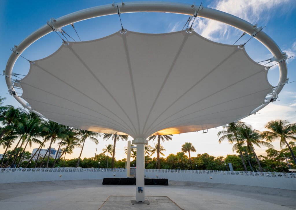 The Rhythm Foundation asked Pvilion to create a solar-powered canopy for shade and rain protection. They delivered a functional work of art inspired by Miami Modern architect Norman N. Giller. It features an enhanced drainage system, turtle-friendly lights and a 70’ canopy that can withstand most Florida wind thresholds or retract for a hurricane. Photo courtesy of Pvilion