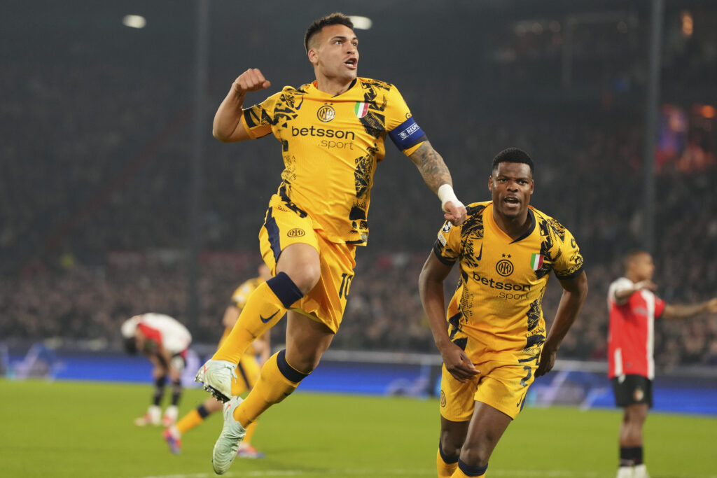 Inter Milan's Lautaro Martinez, left, celebrates after scoring during the Champions League round of 16 first leg soccer match between Feyenoord and Inter Milan in Rotterdam, Netherlands, Wednesday, March 5, 2025.