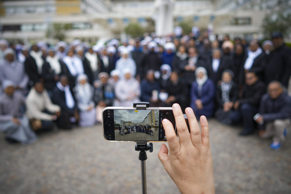 Nuns have a group photo taken at the end of a prayer for Pope Francis in front of the Agostino Gemelli Polyclinic, in Rome, Sunday, March 9, 2025.