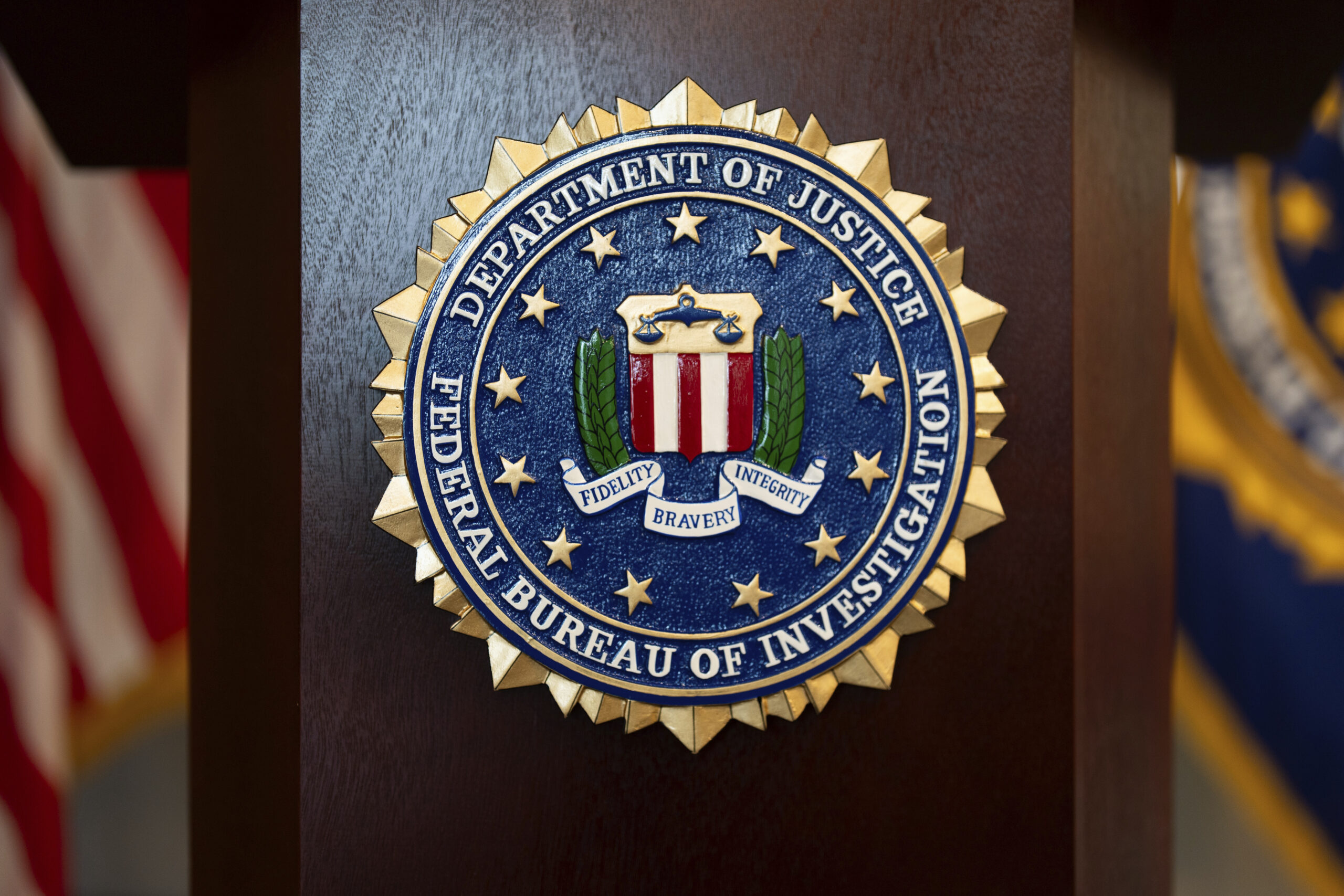 An FBI seal is displayed on a podium before a news conference at the field office in Portland, Ore., Jan. 16, 2025. AP Photo/Jenny Kane, File