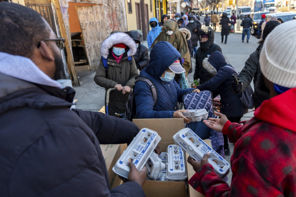 Abou Sow hands out cartons of eggs to people waiting in line to receive free eggs from FarmerJawn Agriculture, Friday, March 21, 2025, in the Harlem neighborhood of New York. AP Photo/Julia Demaree Nikhinson