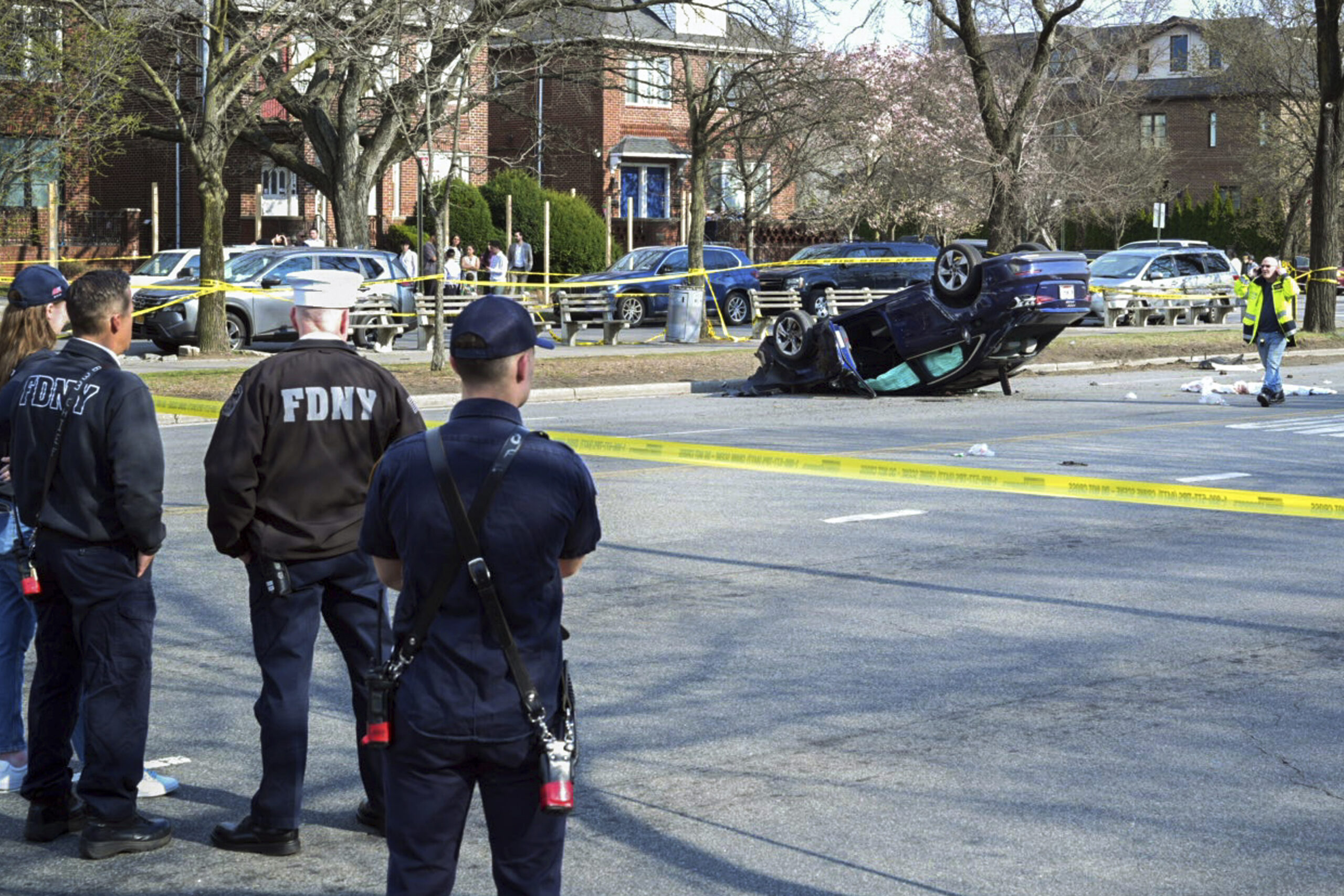 This image provided by the Office of the New York Mayor shows the scene, Saturday, March 29, 2025, in Gravesend, where a woman driving on a suspended license was speeding and failed to yield after stopping at a red light, collided with another vehicle and then into a family walking in the crosswalk. Mayoral Photography Office/Justin Persaud via AP