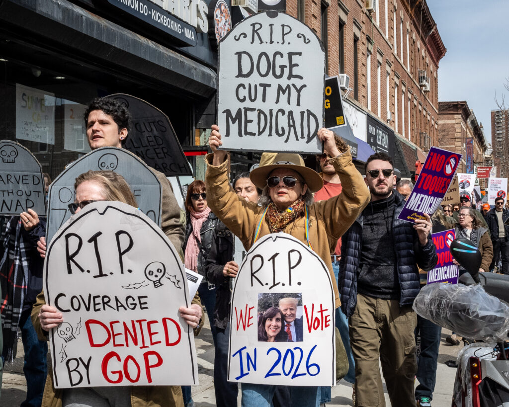A coalition of progressive organizations and unions — including Indivisible Brooklyn and 1199 SEIU United Healthcare Workers East — march to the Bay Ridge office of Congresswoman Nicole Malliotakis (R-Brooklyn) in Brooklyn, New York, March 22, 2025, protesting her vote to cut funding for federal health care programs and give tax breaks to billionaires. Brooklyn Eagle photo by Gabriele Holtermann