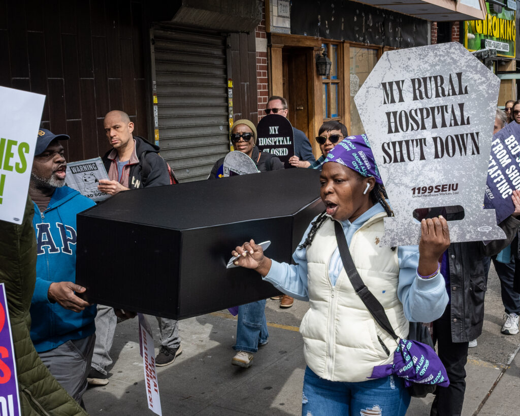 A coalition of progressive organizations and unions — including Indivisible Brooklyn and 1199 SEIU United Healthcare Workers East — march to the Bay Ridge office of Congresswoman Nicole Malliotakis (R-Brooklyn) in Brooklyn, New York, March 22, 2025, protesting her vote to cut funding for federal health care programs and give tax breaks to billionaires. Brooklyn Eagle photo by Gabriele Holtermann