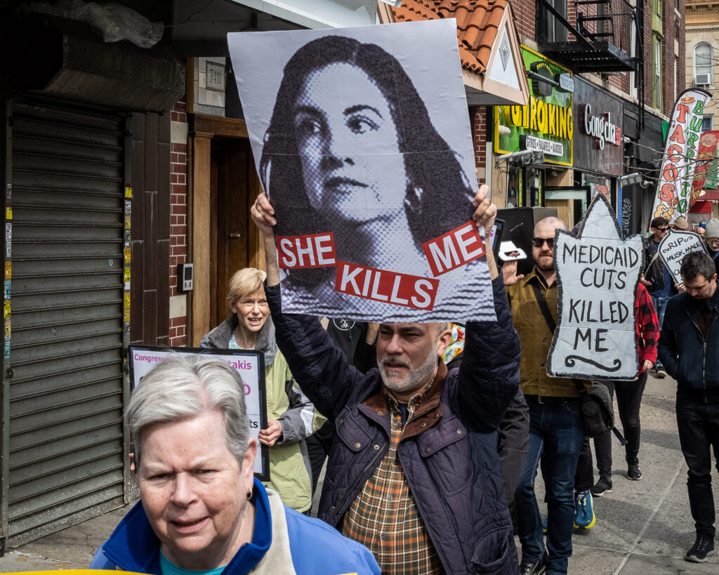 A coalition of progressive organizations and unions — including Indivisible Brooklyn and 1199 SEIU United Healthcare Workers East — march to the Bay Ridge office of Congresswoman Nicole Malliotakis (R-Brooklyn) in Brooklyn, New York, March 22, 2025, protesting her vote to cut funding for federal health care programs and give tax breaks to billionaires. Brooklyn Eagle photo by Gabriele Holtermann
