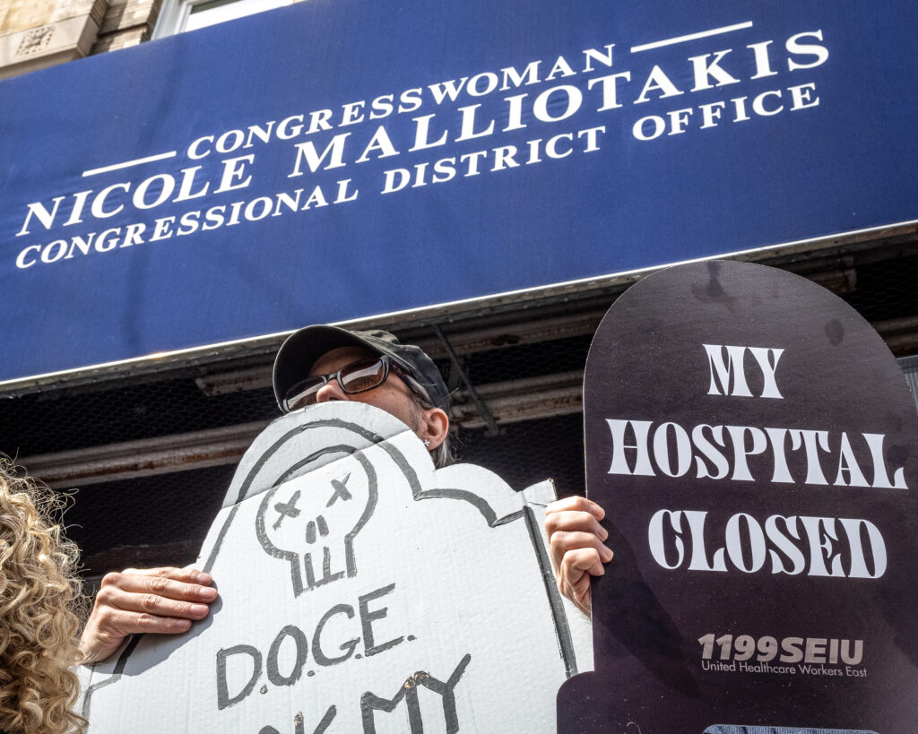A coalition of progressive organizations and unions — including Indivisible Brooklyn and 1199 SEIU United Healthcare Workers East — rally outside the Bay Ridge office of Congresswoman Nicole Malliotakis (R-Brooklyn), in Brooklyn, New York, March 22, 2025, protesting her vote to cut funding for federal health care programs and give tax breaks to billionaires. Brooklyn Eagle photo by Gabriele Holtermann