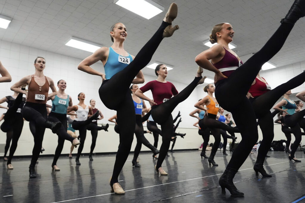Dancers rehearse choreography before an audition for the Radio City Rockettes at Radio City Music Hall, Tuesday, April 22, 2025, in New York.