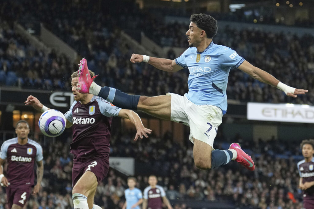 Manchester City's Omar Marmoush, right, in action against Aston Villa's Matty Cash during the English Premier League soccer match between Manchester City and Aston Villa at Etihad stadium in Manchester, England, Tuesday, April 22, 2025.