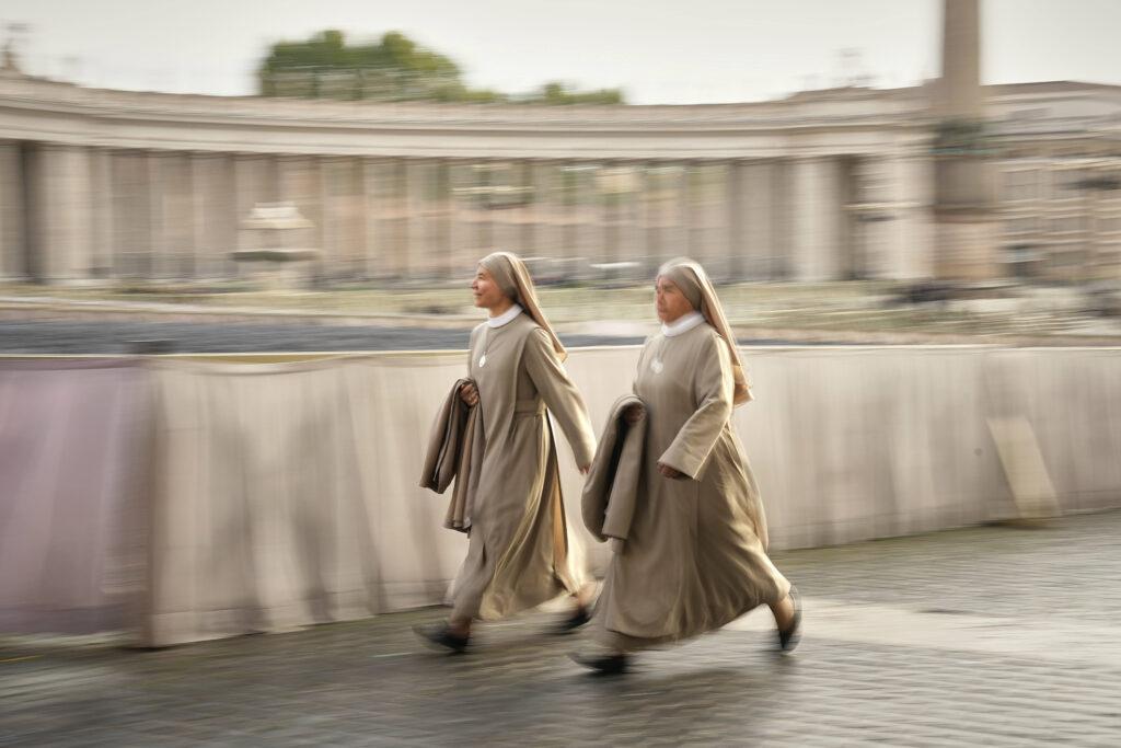Nuns arrive in St. Peter's Square as they await the arrival of the body of Pope Francis, who will lie in state at St. Peter's Basilica for three days, at the Vatican, Wednesday, April 23, 2025.