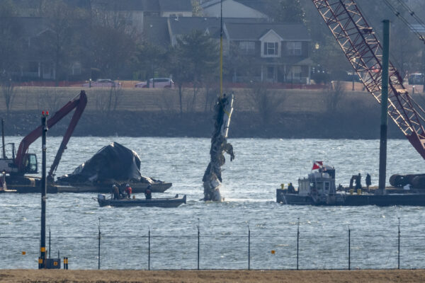 A piece of wreckage is lifted from the water onto a salvage vessel near the site in the Potomac River of a mid-air collision between an American Airlines jet and a Black Hawk helicopter, at Ronald Reagan Washington National Airport, Feb. 4, 2025, in Arlington, Va. AP Photo/Ben Curtis, File