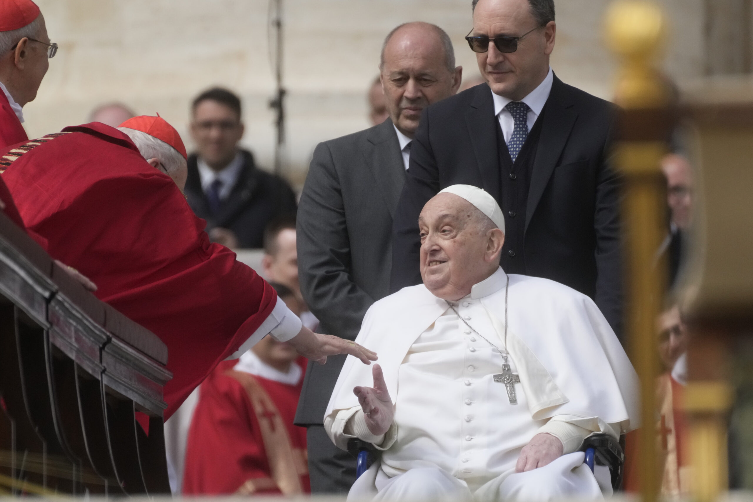 A cardinal reaches out for Pope Francis as he arrives at the end of the mass on Palm Sunday in St. Peter's Square at The Vatican, Sunday, April 13, 2025. Photo: Gregorio Borgia/AP