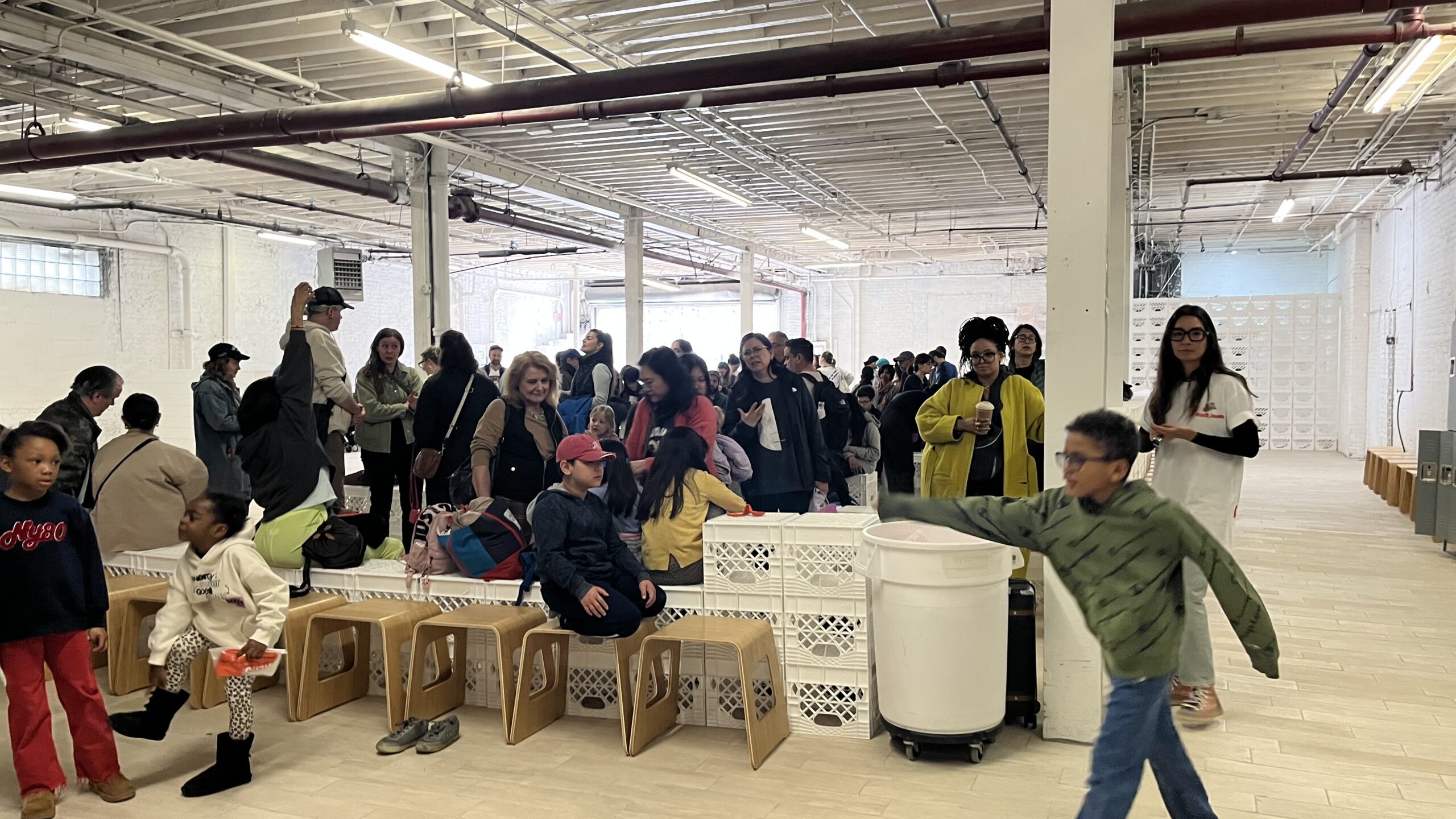 After a block-long line outside the building, participants waited in another line that nearly filled the room. Brooklyn Eagle photo by Ashlyn Beck