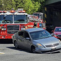A sinkhole opened on Old Fulton Street on Thursday, trapping a Nissan Altima up to its right front bumper. Photo courtesy of Eric Han