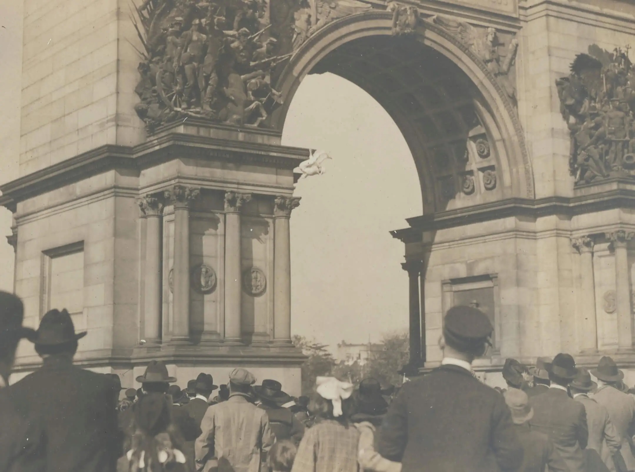 Gardiner performs for the crowd while climbing the Soldiers and Sailors Memorial Arch at Grand Army Plaza in Brooklyn. Photo via the National Archives