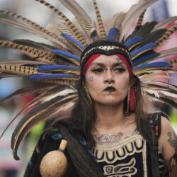 Jasmine Flores wears indigenous Mexican clothing as she and thousands of people march in a May Day rally and protest Thursday, May 1, 2025, in Chicago.