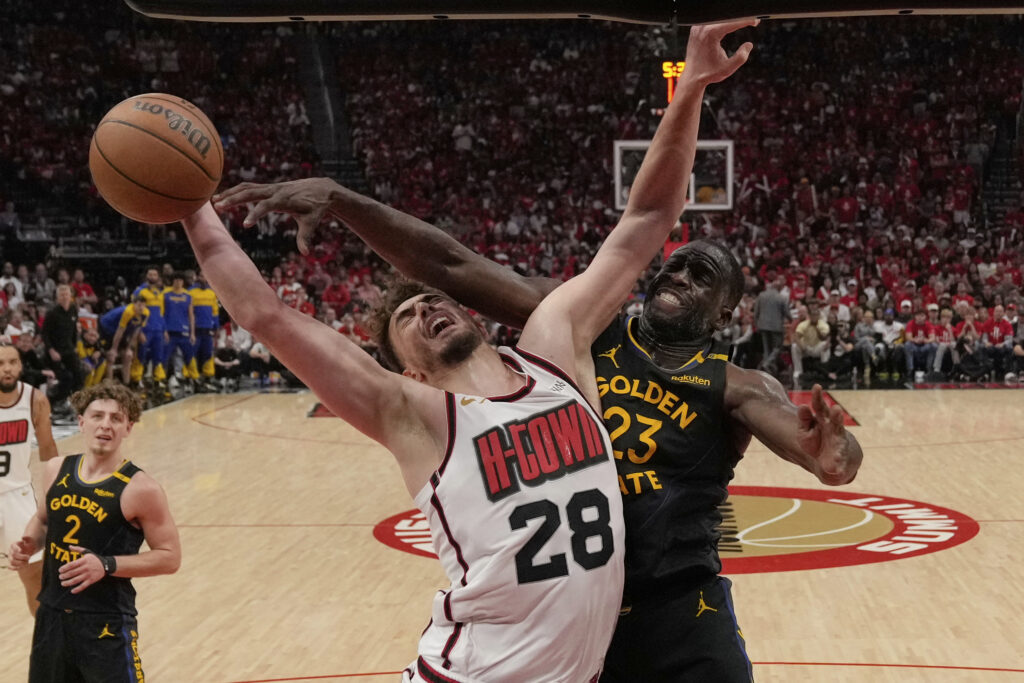 Houston Rockets' Alperen Sengun (28) goes up for a shot as Golden State Warriors' Draymond Green (23) defends during the second half of Game 7 of an NBA basketball first-round playoff series Sunday, May 4, 2025, in Houston.