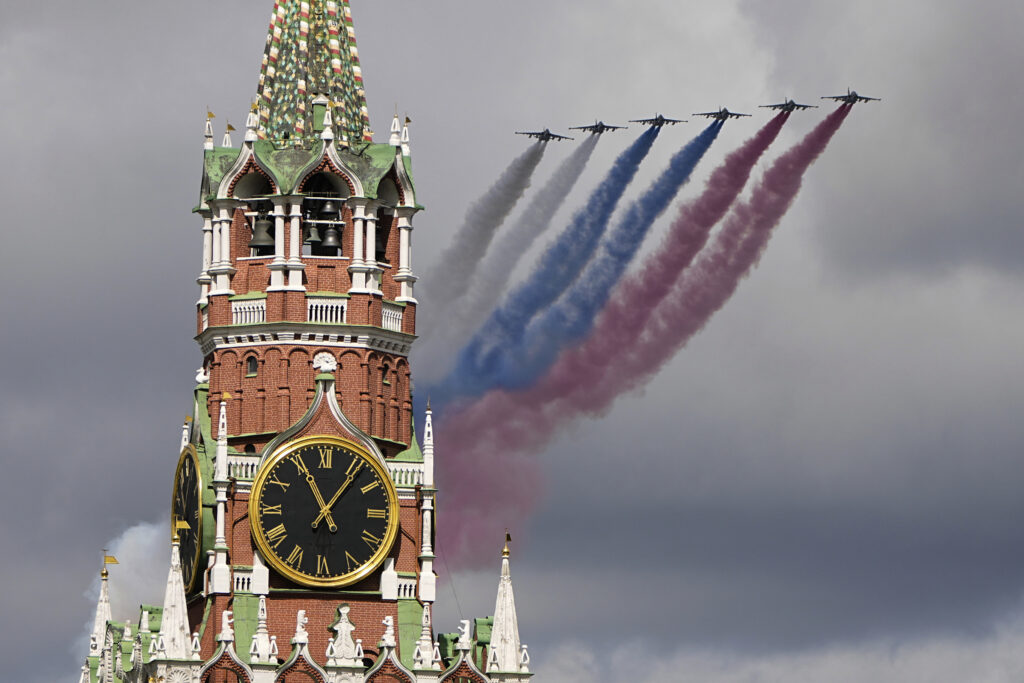 Russian Air Force Su-25 jets fly over Red Square leaving trails of smoke in the colors of the Russian national flag during the Victory Day military parade rehearsal with the Spasskaya Tower in Moscow, Russia, on Monday, May 5, 2025, marking the 80th anniversary of the end of World War II.