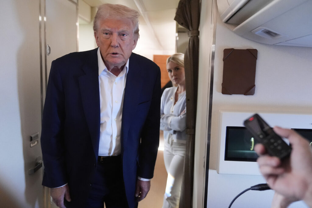 President Donald Trump talks with reporters on Air Force One as he heads back to Washington, Sunday, May 4, 2025, from West Palm Beach, Fla.