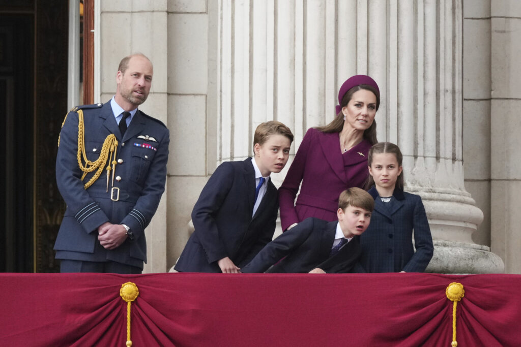 Britain's William, Prince of Wales, left, Prince George, second left, Prince Louis, center, Kate, Princess of Wales, second right, and Princess Charlotte, right, as they appear on the balcony of Buckingham Palace to watch the flypast during the V-E Day 80th anniversary parade in London, Monday, May 5, 2025.