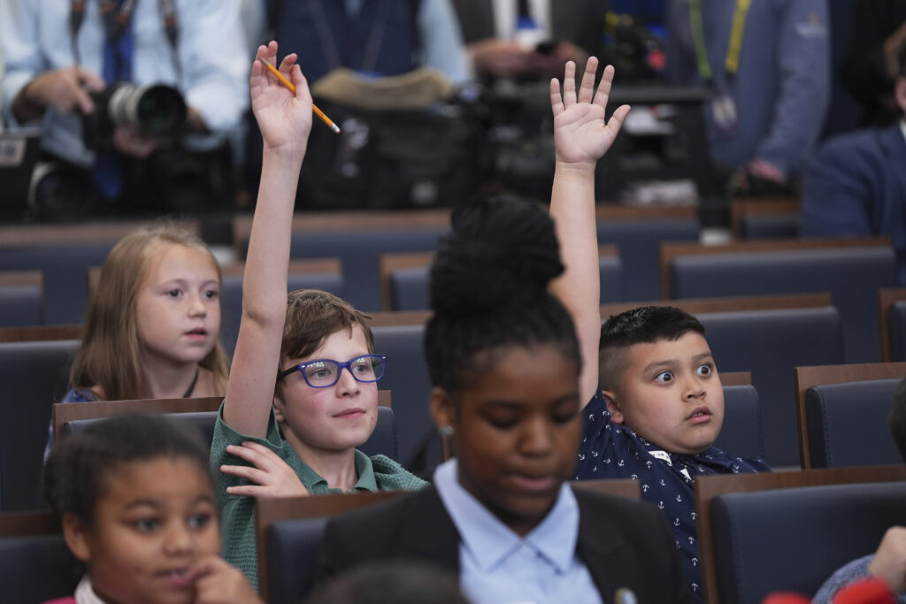 Children raise their hands as White House press secretary Karoline Leavitt speaks during a briefing for "Take Our Sons and Daughters To Work Day" at the White House, Tuesday, May 20, 2025, in Washington.
