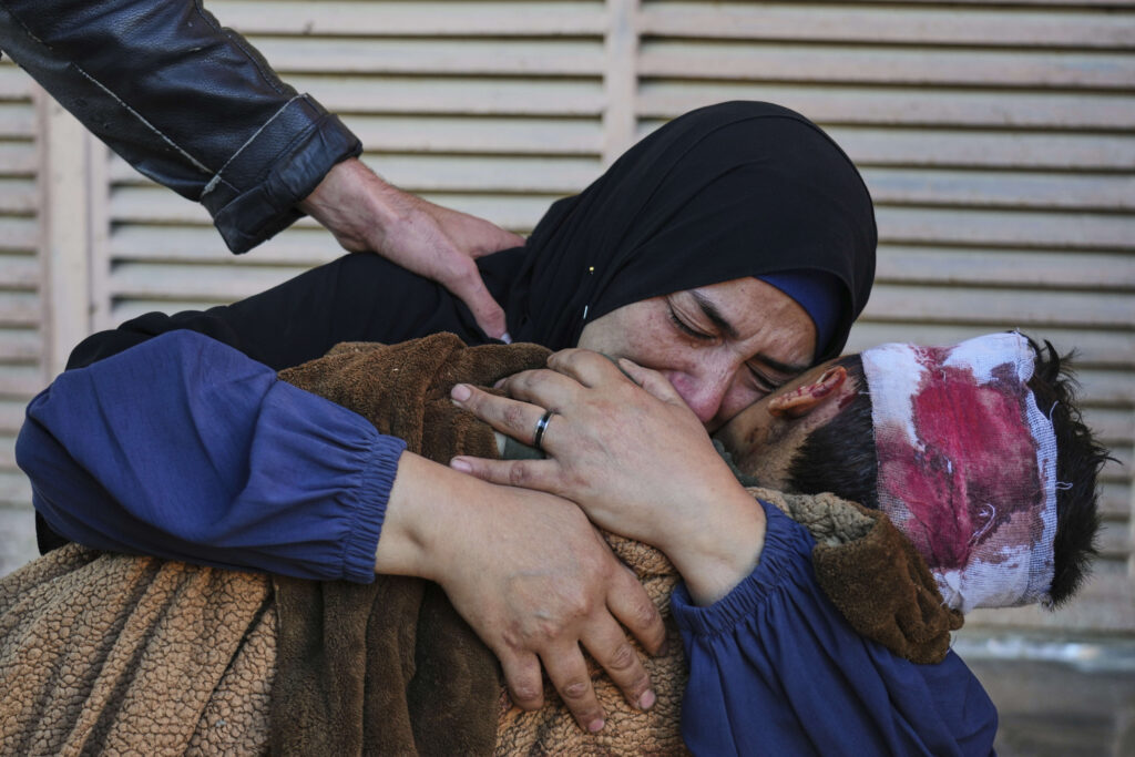 Palestinian Maha Elayan weeps as she embraces the body of her 7-year-old son, Qasim, who was killed in an overnight Israeli airstrike on a UN school used as a shelter, ahead of his burial at Al-Aqsa Hospital in Deir al-Balah, in the central Gaza Strip, Wednesday, May 7, 2025.