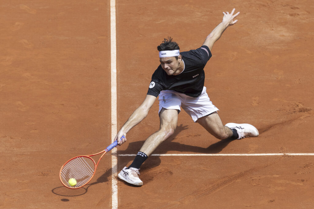 Taylor Fritz of the U.S. returns a ball to Quentin Halys of France during the round of 16, at the ATP 250 Geneva Open Tennis Tournament, in Geneva, Switzerland, Wednesday, May 21, 2025