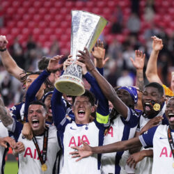 Tottenham's Son Heung-min holds the trophy aloft as he celebrates with teammates after winning the Europa League final soccer match against Manchester United at the San Mames Stadium in Bilbao, Spain, Wednesday, May 21, 2025.