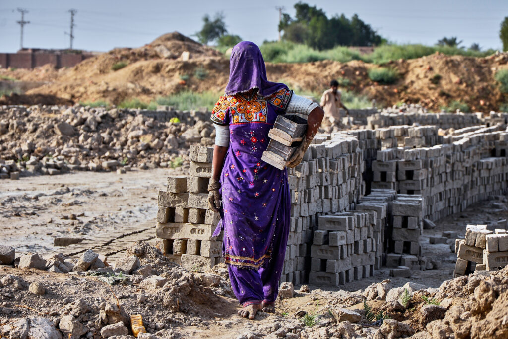 A woman works at a brick kiln during May Day, on the outskirts of Hyderabad, Pakistan, Thursday, May 1, 2025.
