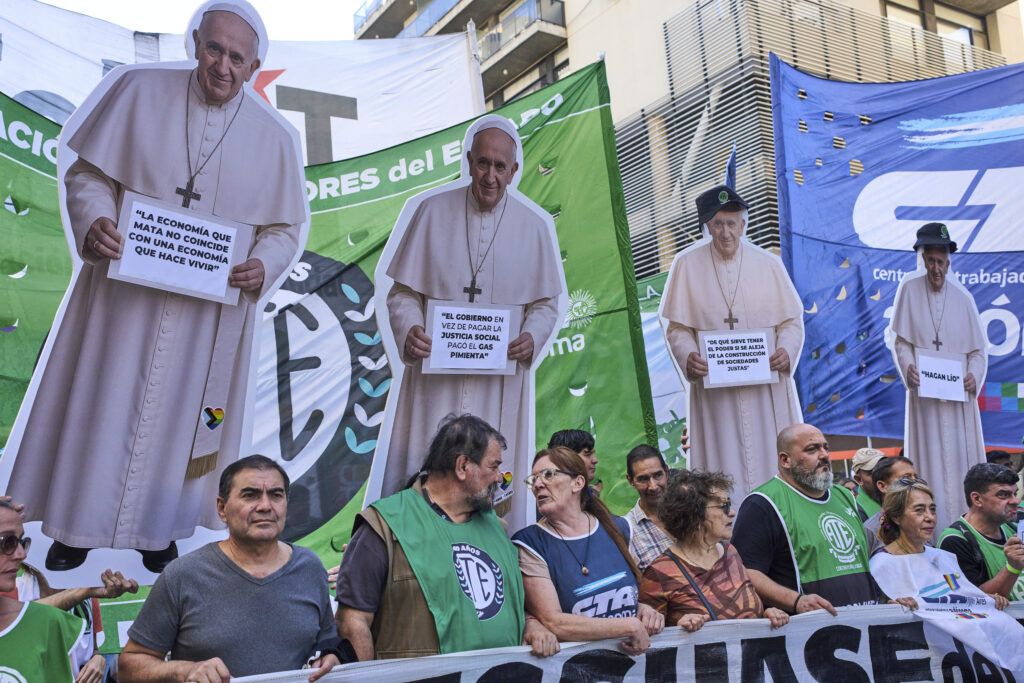 Demonstrators march with cardboard cutouts of the late Pope Francis a day before International Workers' Day in Buenos Aires, Argentina, Wednesday, April 30, 2025.