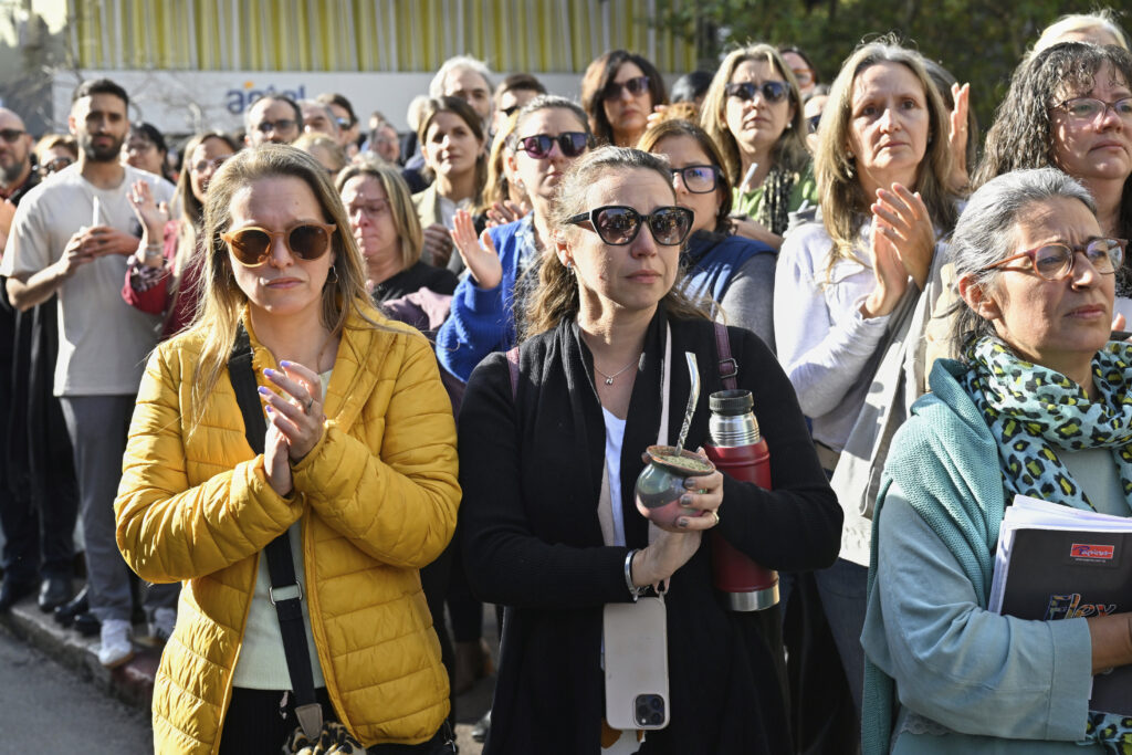 People watch the funeral procession of the late former President Jose Mujica from the presidential palace to the National Assembly in Montevideo, Uruguay, Wednesday, May 14, 2025.