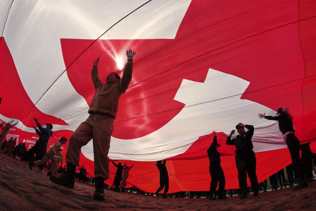 Cadets and young volunteers unfurl a giant replica of the Soviet Flag of Victory, during a continued observance of Victory Day. celebrating 80 years after the victory in World War II, in St. Petersburg, Russia, Thursday, May 15, 2025.