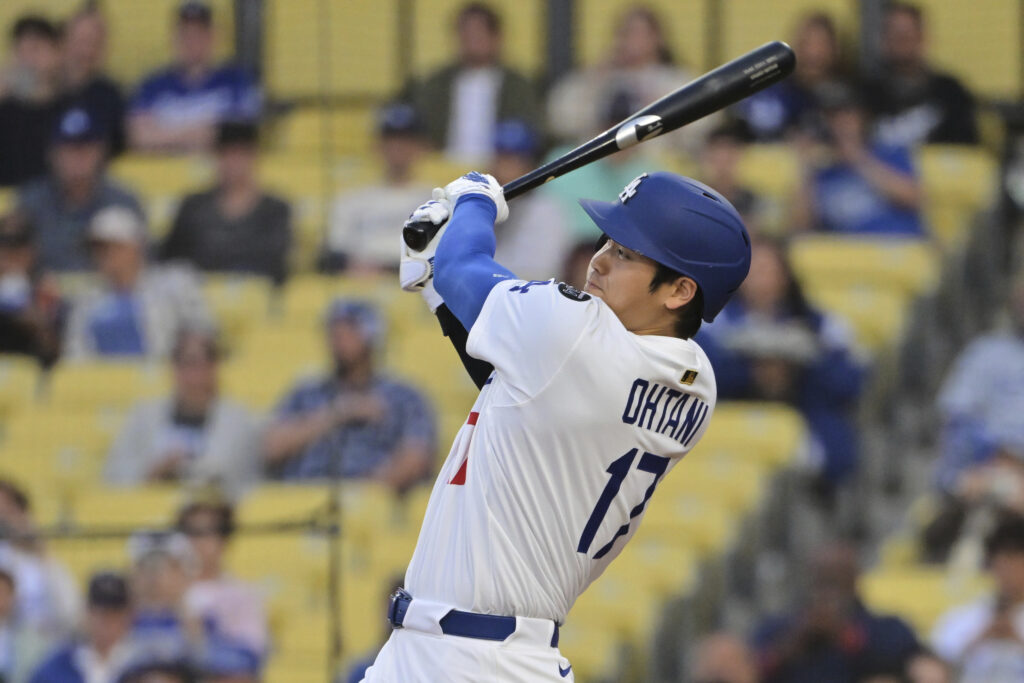 Los Angeles Dodgers' Shohei Ohtani follows through on a solo home run swing in the first inning of a baseball game against the Oakland Athletics, Wednesday, May 14, 2025, in Los Angeles.