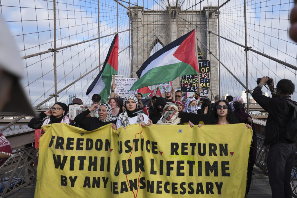 Pro-Palestinian demonstrators march across the Brooklyn Bridge Thursday, May 15, 2025, in New York.