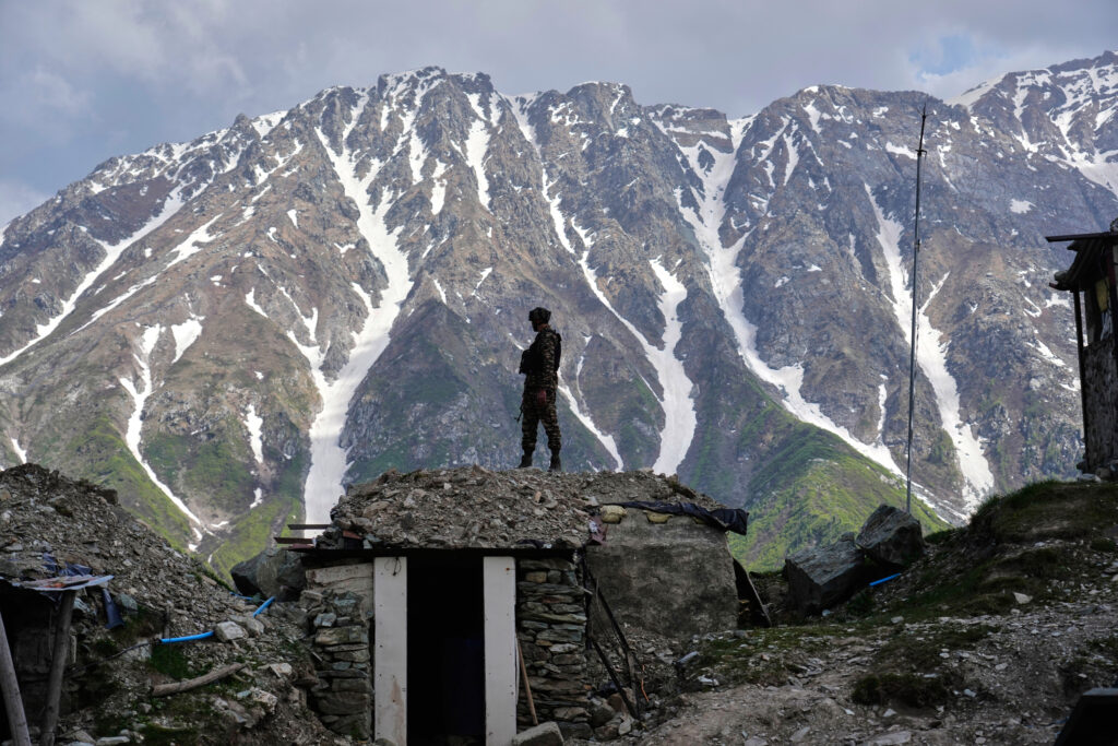 An Indian army soldier keeps a vigil from one of the forward post along the line of control between India and Pakistan during a media tour somewhere in north of Indian-controlled Kashmir, Monday, May 19, 2025.