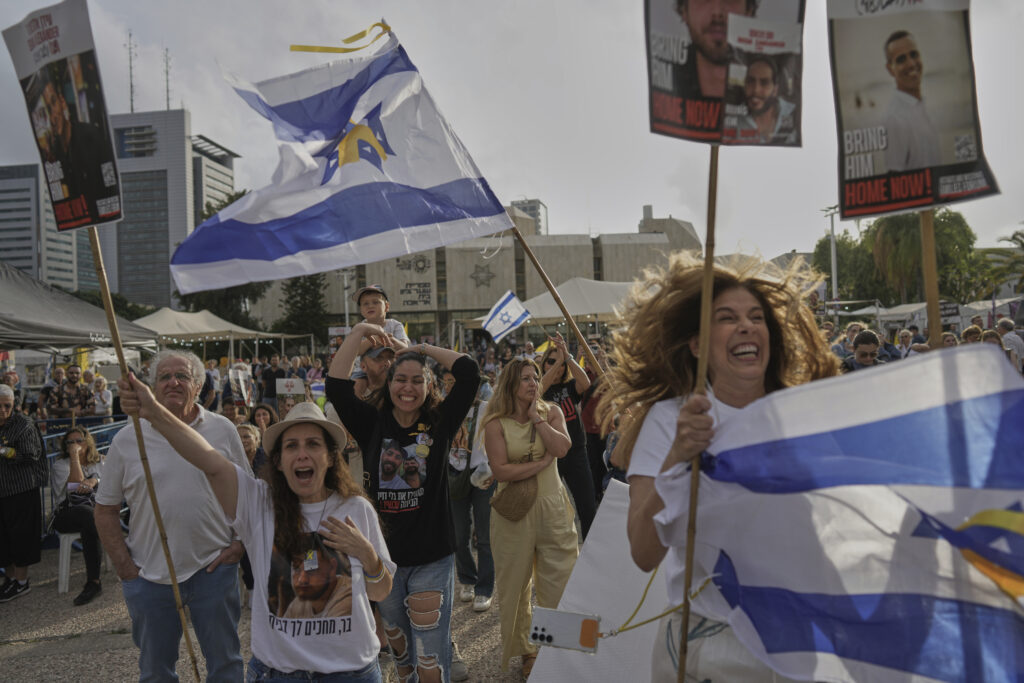 People react as they gather to watch a live broadcast of Israeli-American soldier Edan Alexander to be released from Hamas captivity in Gaza, at a plaza known as the hostages square in Tel Aviv, Monday, May 12, 2025. Alexander was abducted during the Hamas-led attack on his base on October 7, 2023.