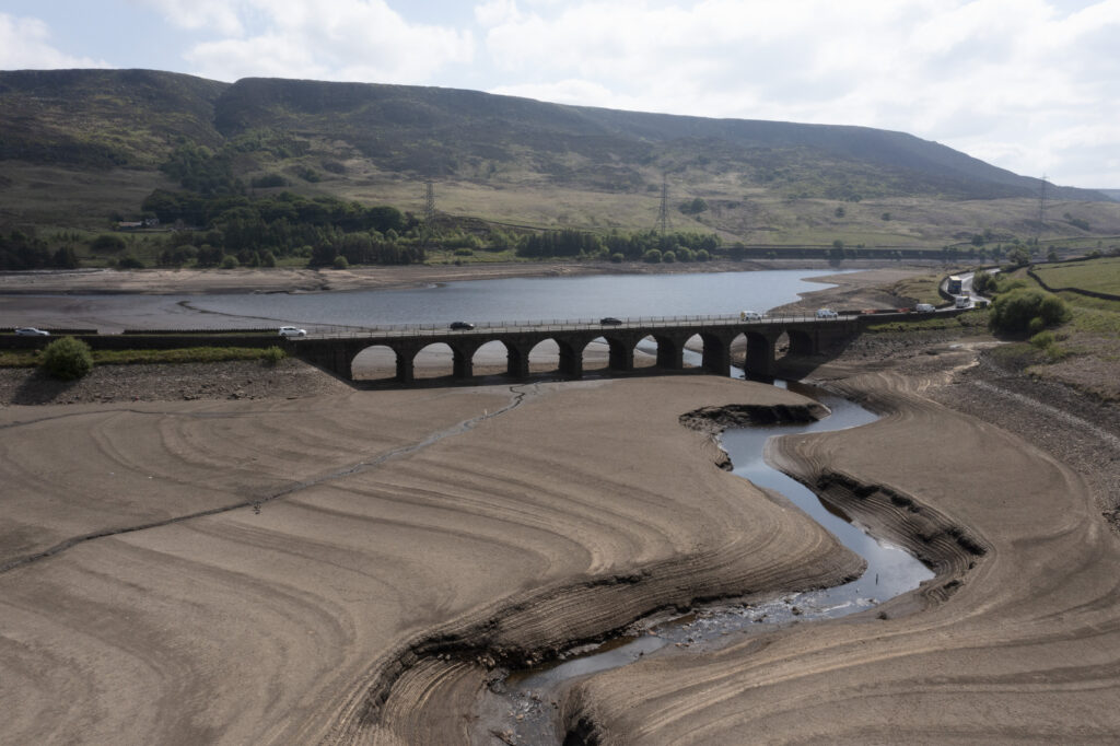 Traffic crosses a bridge at Woodhead Reservoir in Derbyshire as England experiences a significant drought, with reservoir levels at 84% of capacity, lower than the 90% seen in 2022, Woodhead, England, Monday, May 19, 2025.