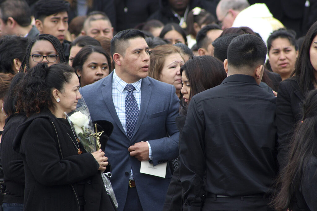 Blanca Llivicura clasps flowers and a crucifix following the funeral of her 16-year-old son Justin at St. Joseph the Worker Church in East Patchogue, N.Y., Wednesday, April 19, 2017. The teenager was the youngest of four young men found slain in a suspected MS-13 gang killing in a Central Islip park on April 11. At center, in blue suit, is Joselo Lucero whose brother, Marcelo Lucero, was killed in 2008 in nearby Patchogue, by a group of young men who admitted they routinely attacked Hispanic victims. Photo: Frank Eltman/AP