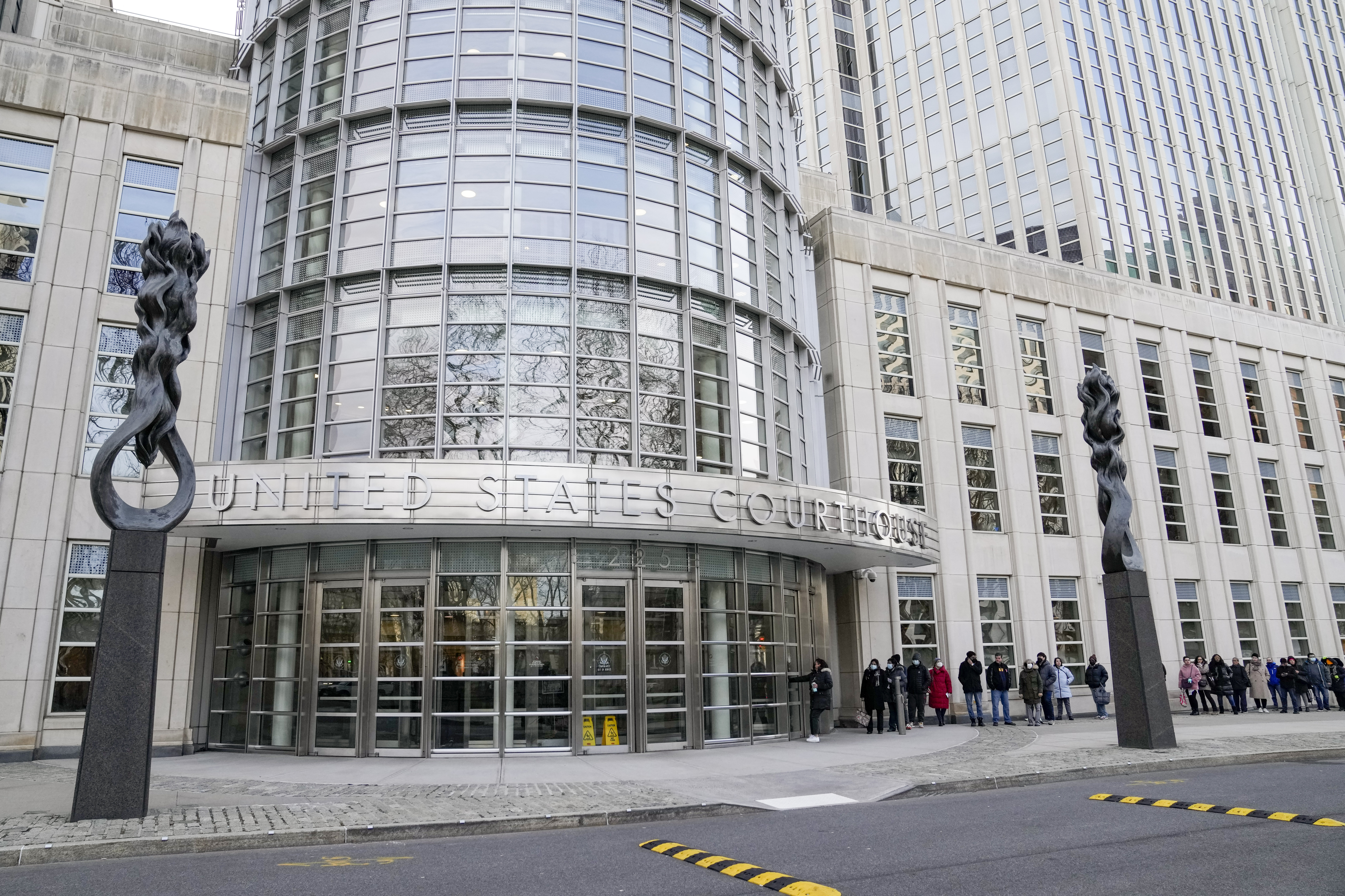 Individuals called for jury duty stand in line before entering Federal court in Brooklyn, Tuesday, Jan. 17, 2023, in New York. AP Photo/John Minchillo