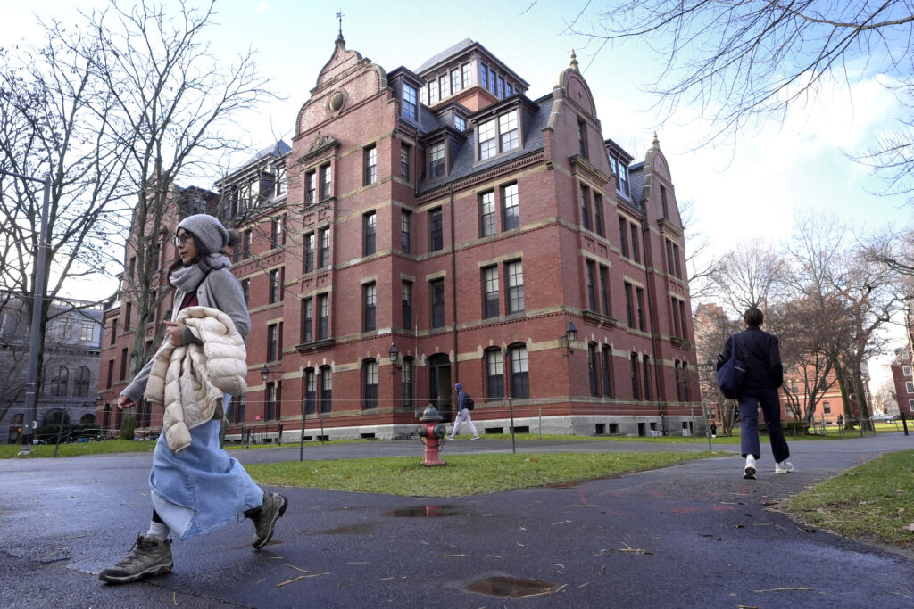 People walk between buildings, Dec. 17, 2024, on the campus of Harvard University in Cambridge, Mass. AP Photo/Steven Senne, File