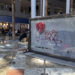 A slab of wall art, The "Battle to Survive a Broken Heart,' created by the artist Banksy, sits on display inside the Brookfield Place atrium, Tuesday, April 29, 2025, in New York. The nearly four-ton piece will be auctioned off on May 21. (AP Photo/Julie Jacobson)