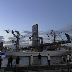 Pedestrians walking along Brooklyn Bridge Park look on as a masted Mexican Navy training ship sits stranded near the Manhattan Bridge after colliding with the Brooklyn Bridge, Saturday, May 17, 2025, in New York. Nick Corso via AP
