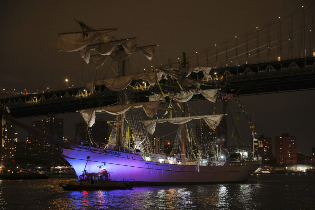 A New York Police Department harbor unit passes in front of the Cuauhtémoc, a masted Mexican Navy training ship as it sits stranded near the Manhattan Bridge after colliding with the Brooklyn Bridge, Saturday, May 17, 2025, in New York. AP Photo/Yuki Iwamura