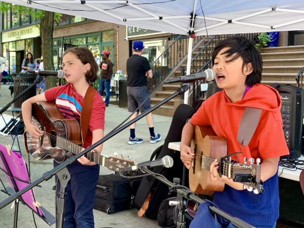 (From left) Louie Piscitello and Caine Nation-Ng perform during the Mother’s Day festivities on Montague Street this past Sunday. Photo: Mary Frost, Brooklyn Eagle