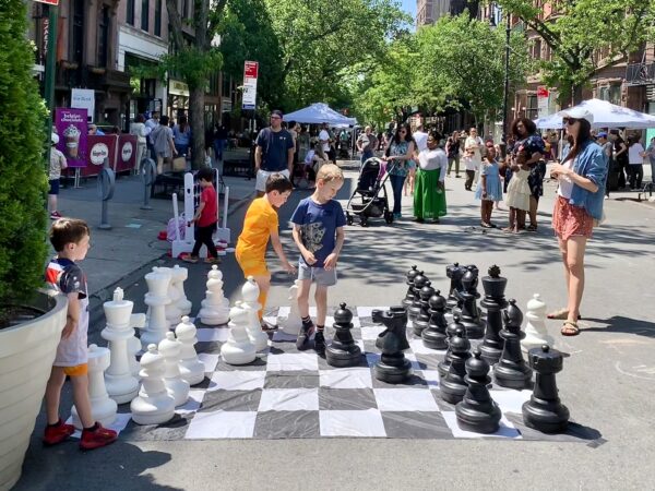 Giant chess, arts and crafts, snacking and just hanging out in the sun were some of Sunday’s activities on Montague Street. Photo: Mary Frost, Brooklyn Eagle