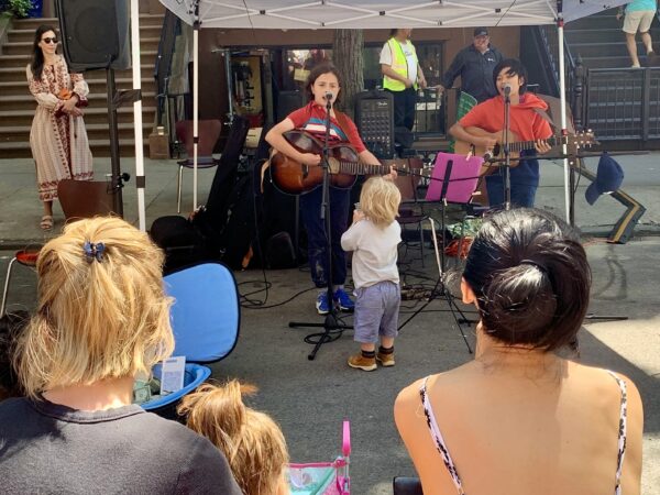 An appreciative audience member claps to the music. Photo: Mary Frost, Brooklyn Eagle
