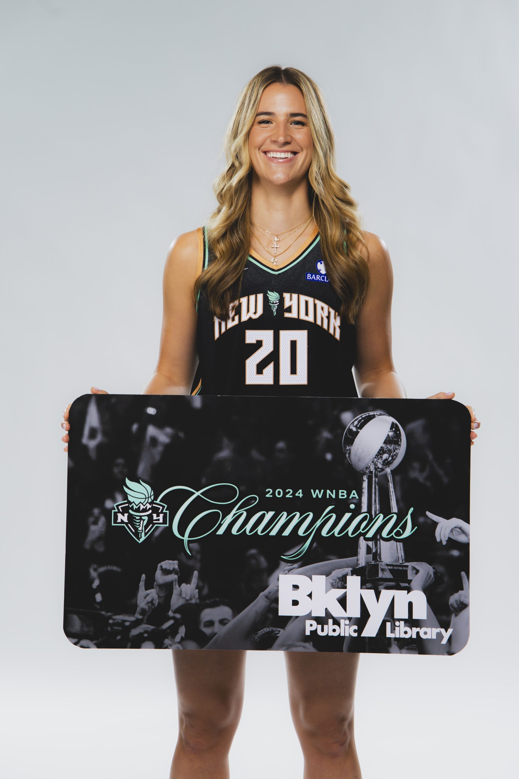 WNBA All-Star Sabrina Ionescu with a giant Brooklyn Public Library card celebrating the Liberty’s championship. Photo courtesy of New York Liberty